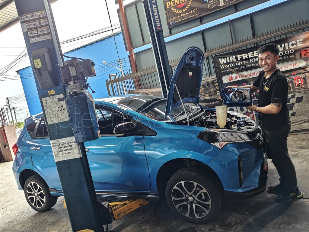 Mechanic calibrating custom electronics on hybrid car
