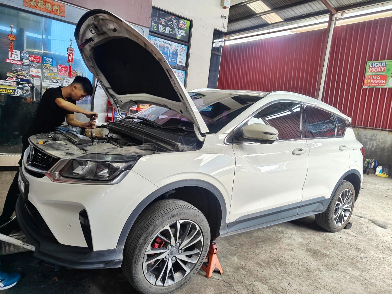 Exhaust system repairs under car hoist